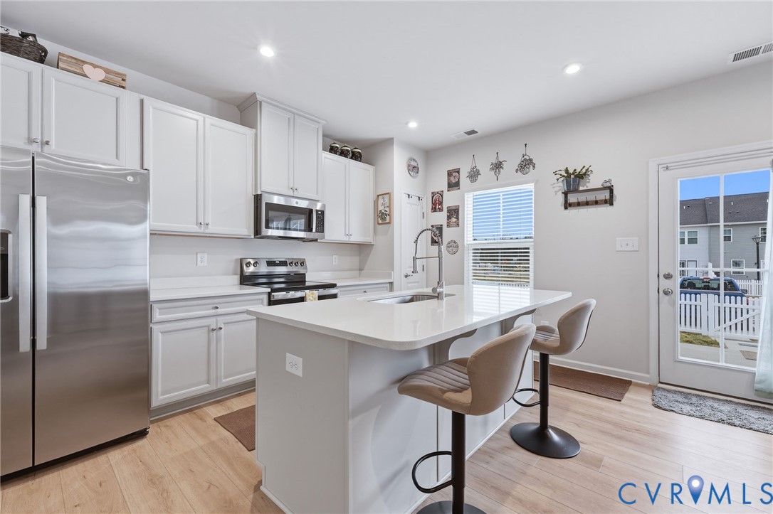 2031 Turtle Parkway Sandston, VA 23150 - Photo 3 of 26 a kitchen with a refrigerator a stove a sink and cabinets