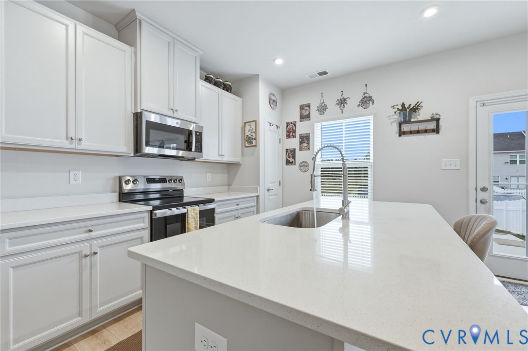 2031 Turtle Parkway Sandston, VA 23150 - Photo 5 of 26 a kitchen with a appliances a microwave and cabinets