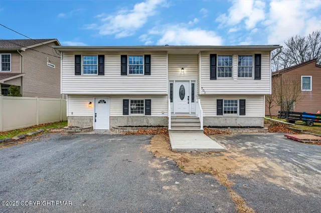 a front view of a house with a road