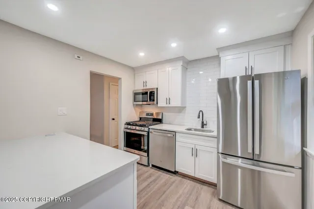 a kitchen that has a sink and a stove