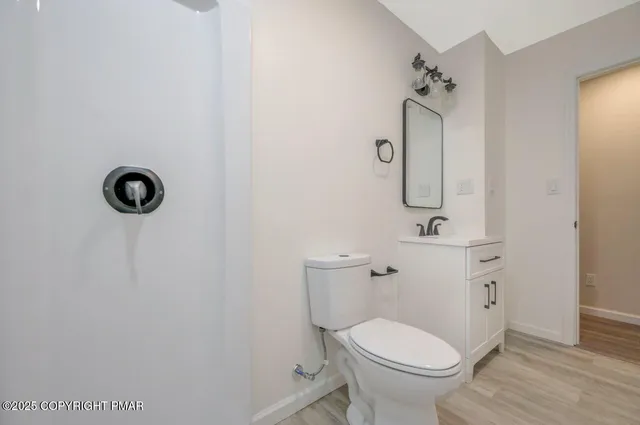 an empty room with a ceiling fan and a window
