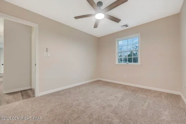 a view of an empty room and a window