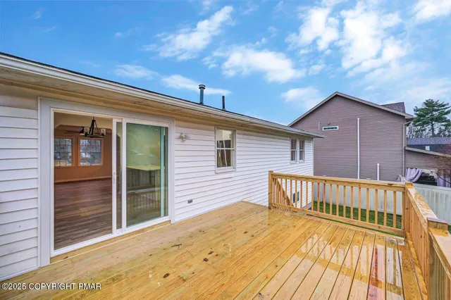 a view of an empty room with wooden floor and closet