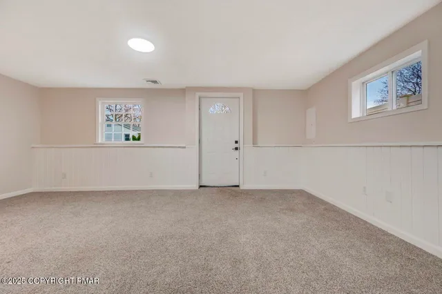 a view of an empty room and a ceiling fan