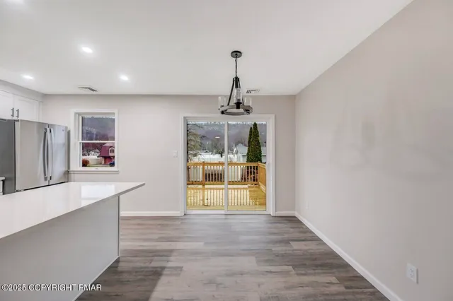 a kitchen with stainless steel appliances a refrigerator sink and microwave