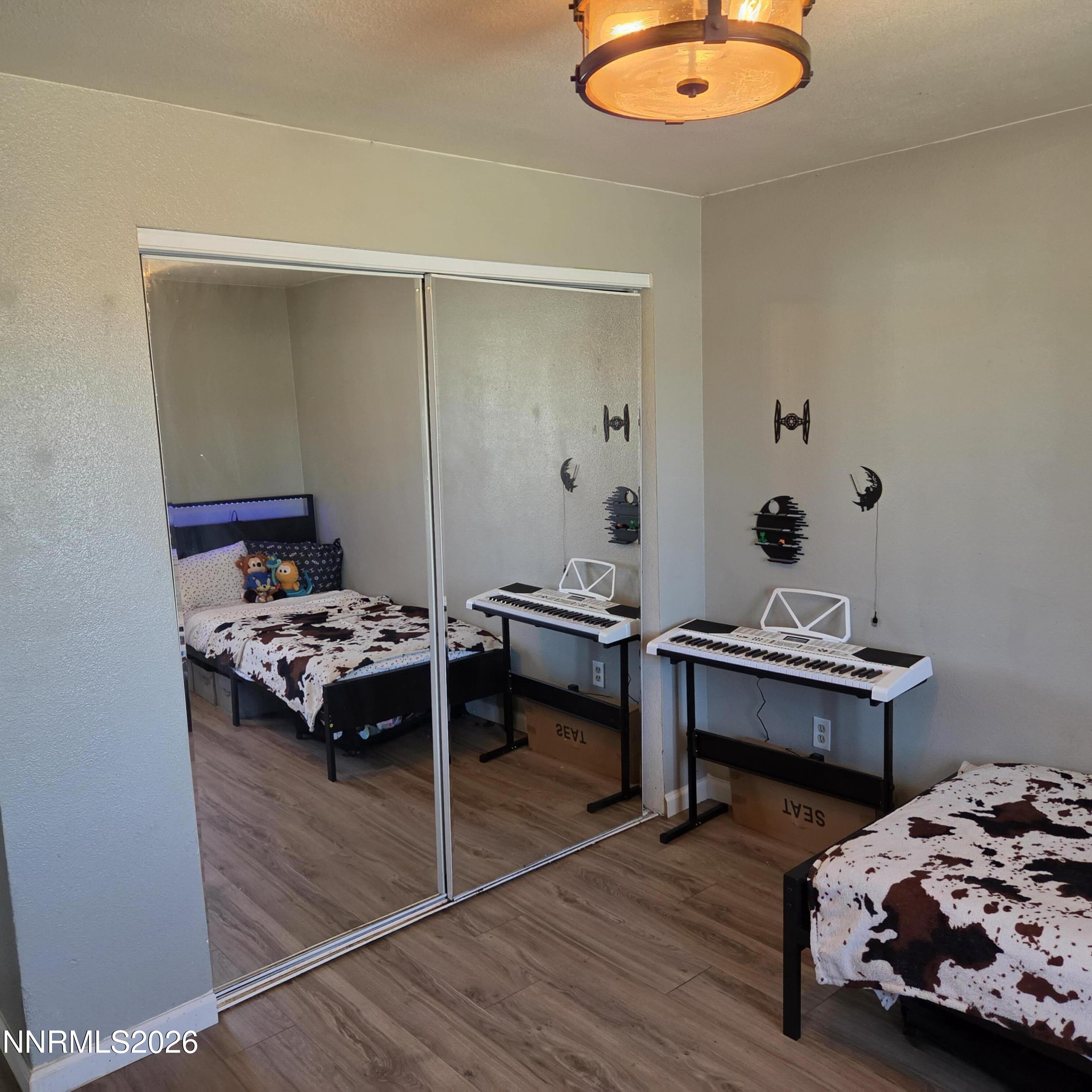 1080 Tarzyn Road Fallon, NV 89406 - Photo 14 of 41 a bedroom with furniture and a wooden floor