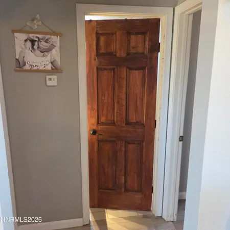 a view of a bedroom with wooden floor
