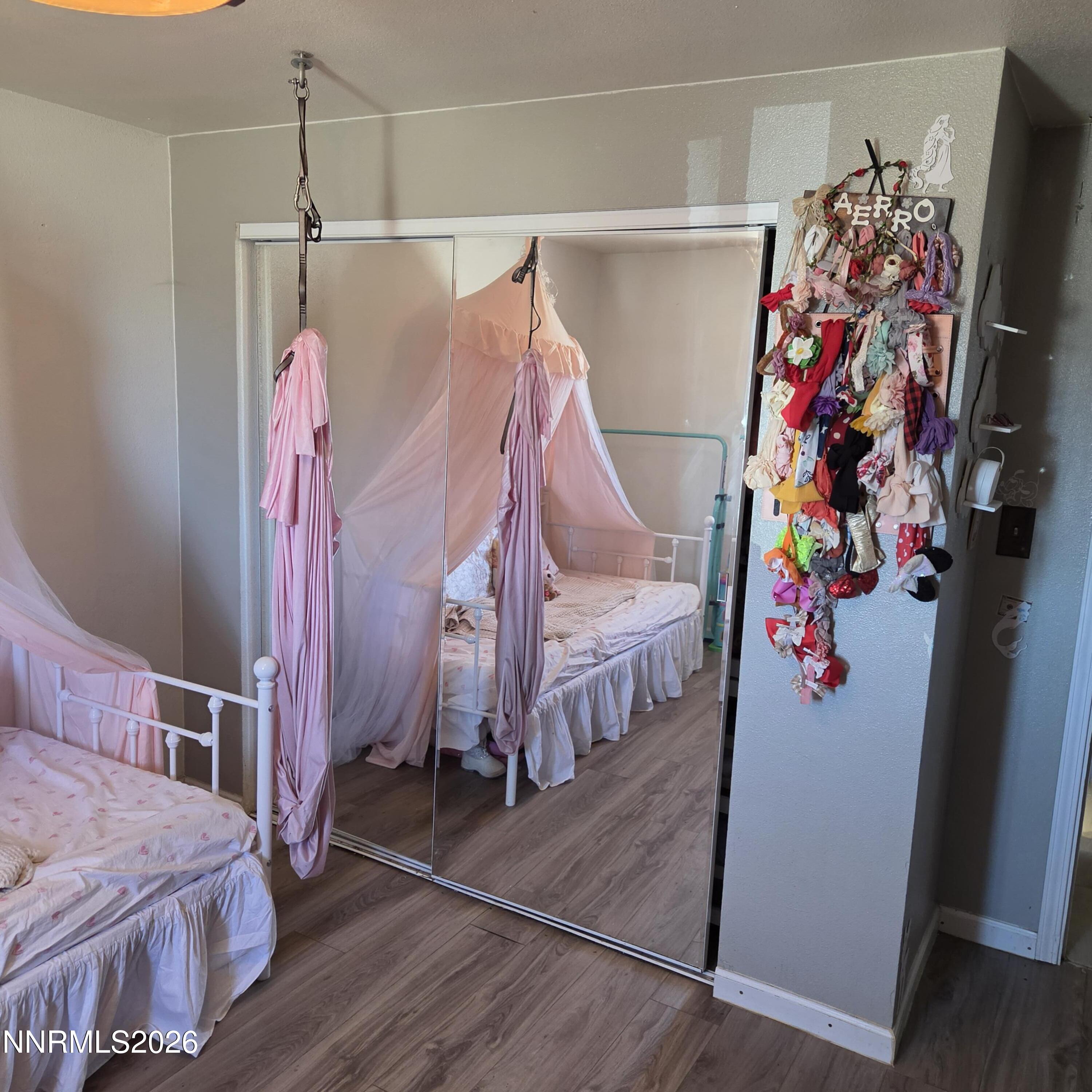 1080 Tarzyn Road Fallon, NV 89406 - Photo 19 of 41 a view of a bedroom with wooden floor