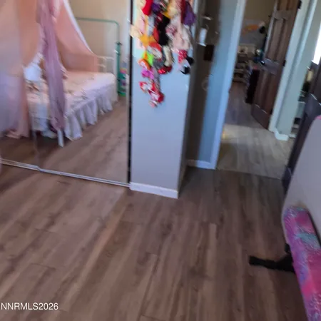 a kitchen with a table chairs and wooden floor