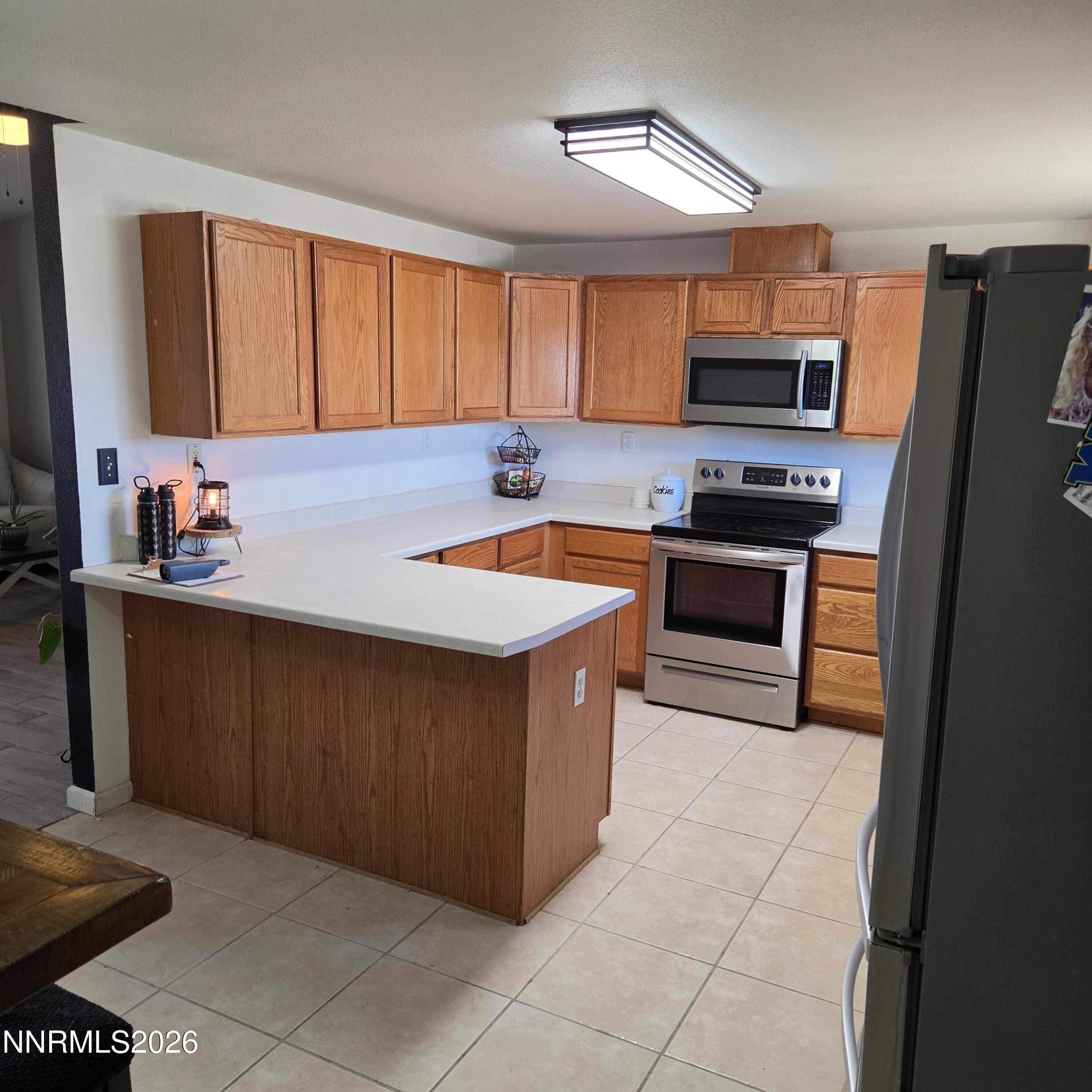 1080 Tarzyn Road Fallon, NV 89406 - Photo 23 of 41 a kitchen with stainless steel appliances granite countertop a stove a sink and a refrigerator