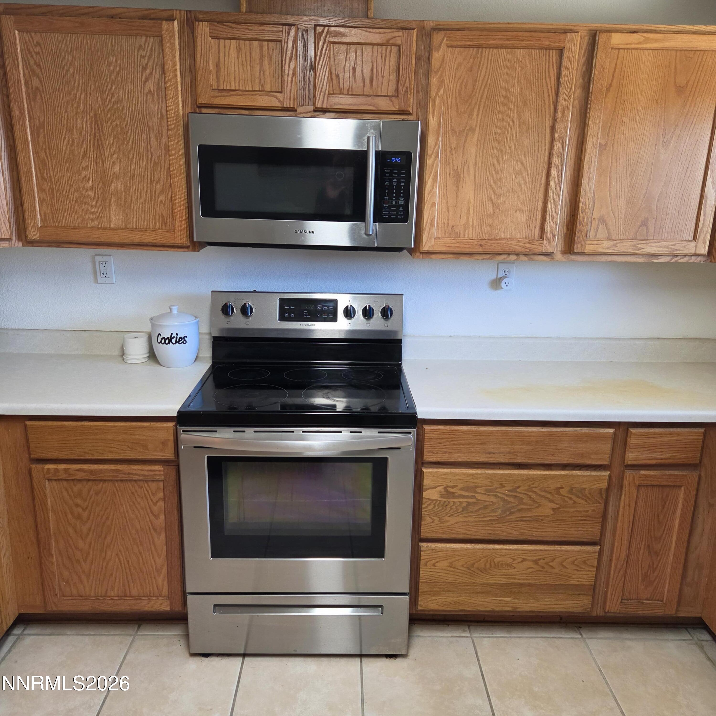 1080 Tarzyn Road Fallon, NV 89406 - Photo 25 of 41 a kitchen with granite countertop white cabinets stainless steel appliances and wooden cabinets