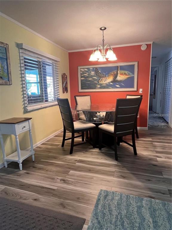 2295 North Beach Road, Unit 23 Englewood, FL 34223 - Photo 12 of 19 a view of a dining room with furniture window and wooden floor