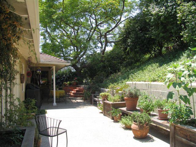 519 Fellowship Road Santa Barbara, CA 93109 - Photo 6 of 16 a view of a patio with table and chairs potted plants and large tree