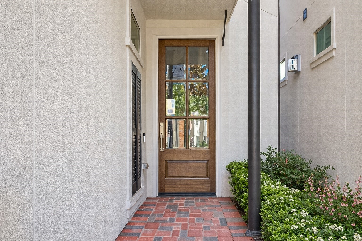 122 Gateway Park Place Spring, TX 77380 - Photo 4 of 44 A welcoming covered entry with brick pavers, modern stucco, and a glass-paneled wood front door.