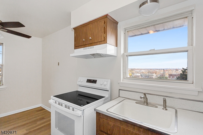 145 Arnot Street, Unit 4B Lodi, NJ 07644 - Photo 11 of 21 a kitchen with a stove and a sink