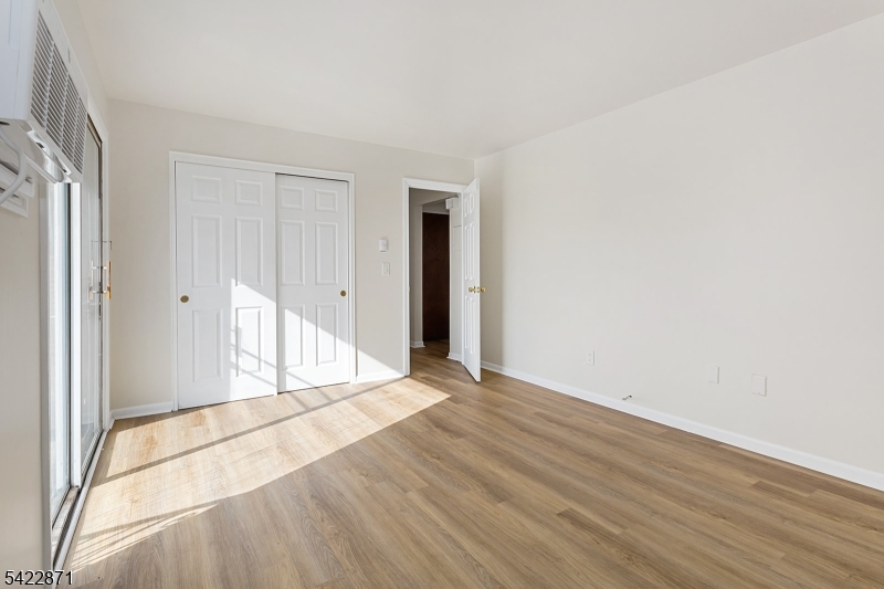 145 Arnot Street, Unit 4B Lodi, NJ 07644 - Photo 15 of 21 a view of an empty room with wooden floor