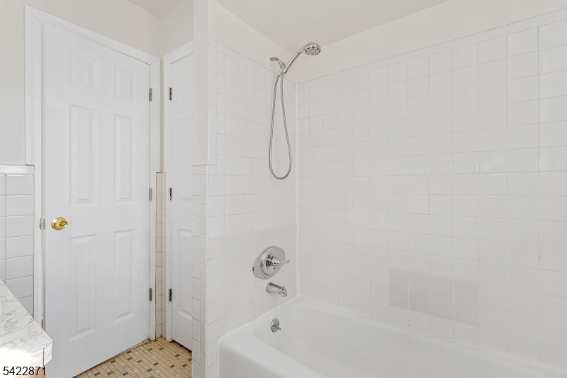 145 Arnot Street, Unit 4B Lodi, NJ 07644 - Photo 18 of 21 a bathroom with a bath tub with a shower