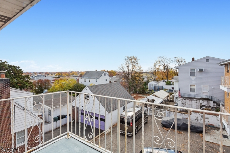 145 Arnot Street, Unit 4B Lodi, NJ 07644 - Photo 19 of 21 aerial view of a house with wooden fence
