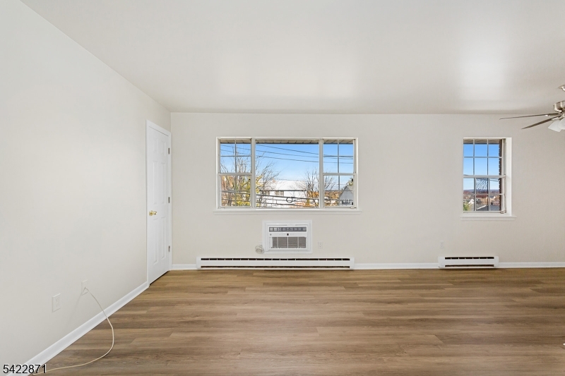145 Arnot Street, Unit 4B Lodi, NJ 07644 - Photo 4 of 21 a view of empty room with wooden floor