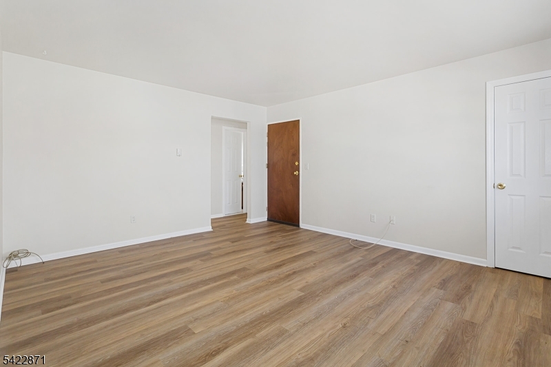 145 Arnot Street, Unit 4B Lodi, NJ 07644 - Photo 6 of 21 a view of an empty room with wooden floor