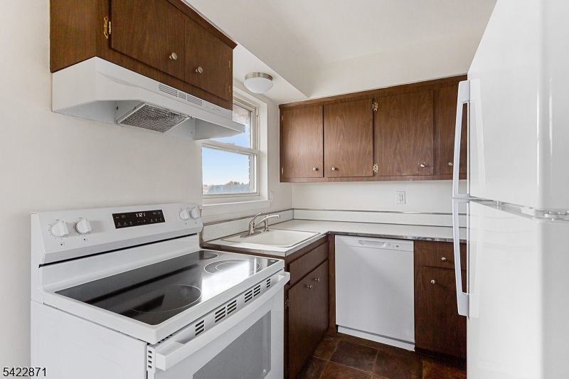 145 Arnot Street, Unit 4B Lodi, NJ 07644 - Photo 9 of 21 a kitchen with a stove cabinets and a refrigerator