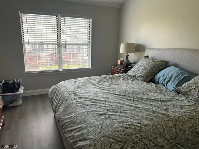 a large bed sitting in a bedroom next to a window