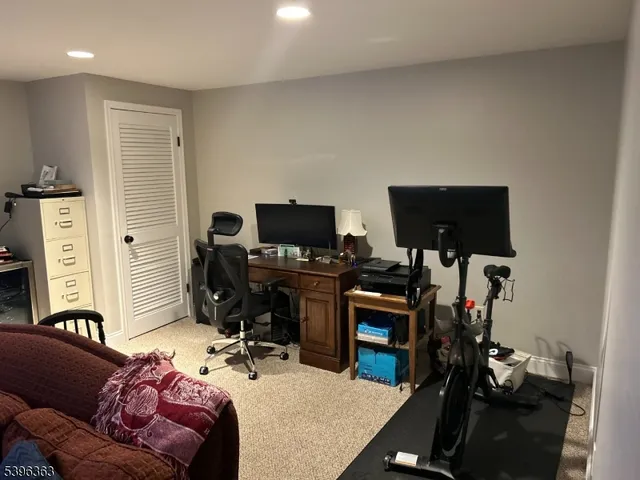 a living room with furniture a flat screen tv and a window