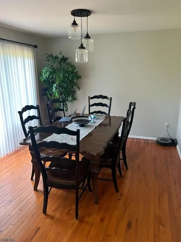 a view of a dining room with furniture and window