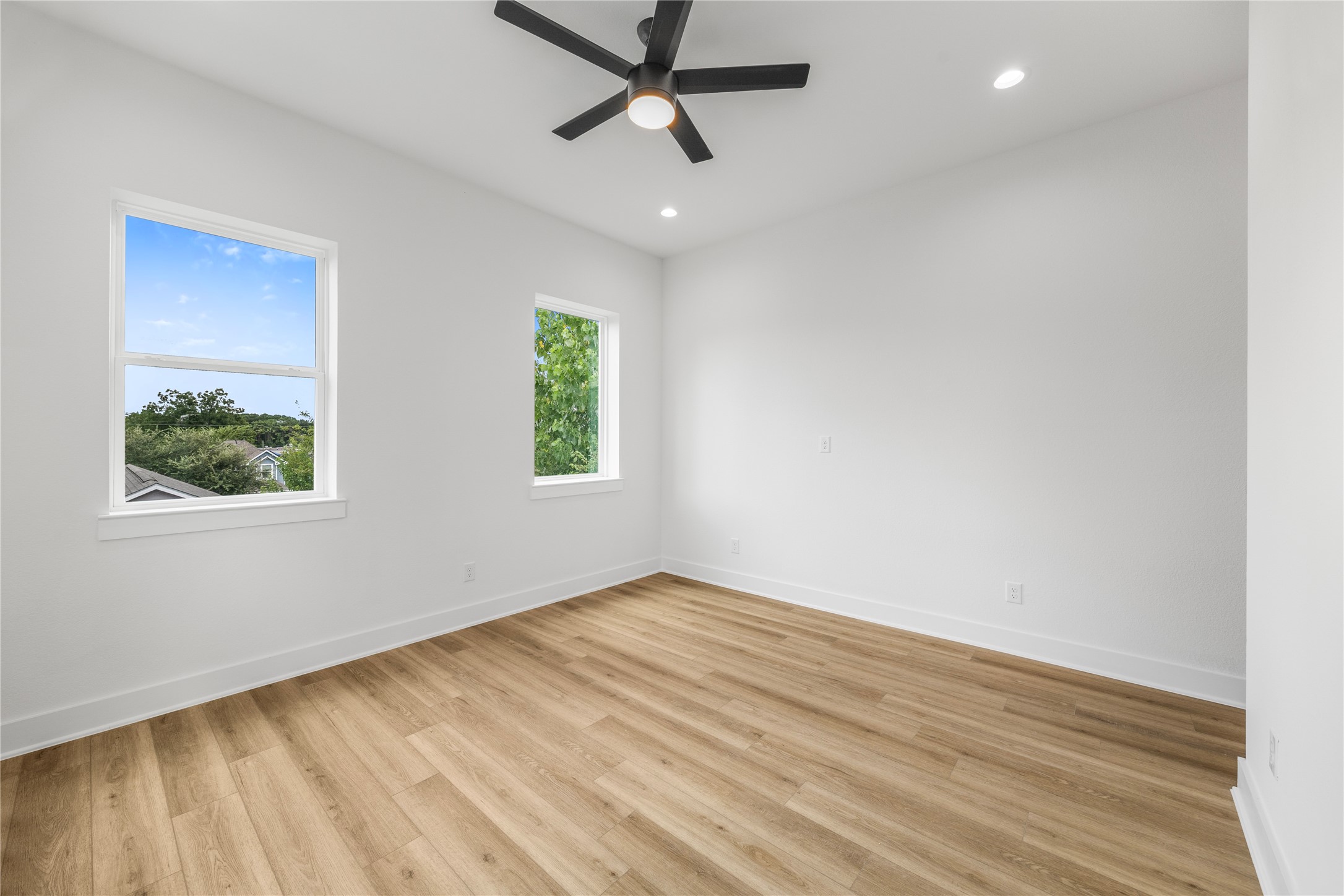 7901 Cora Street, Unit B Houston, TX 77088 - Photo 13 of 21 wooden floor in an empty room with a window