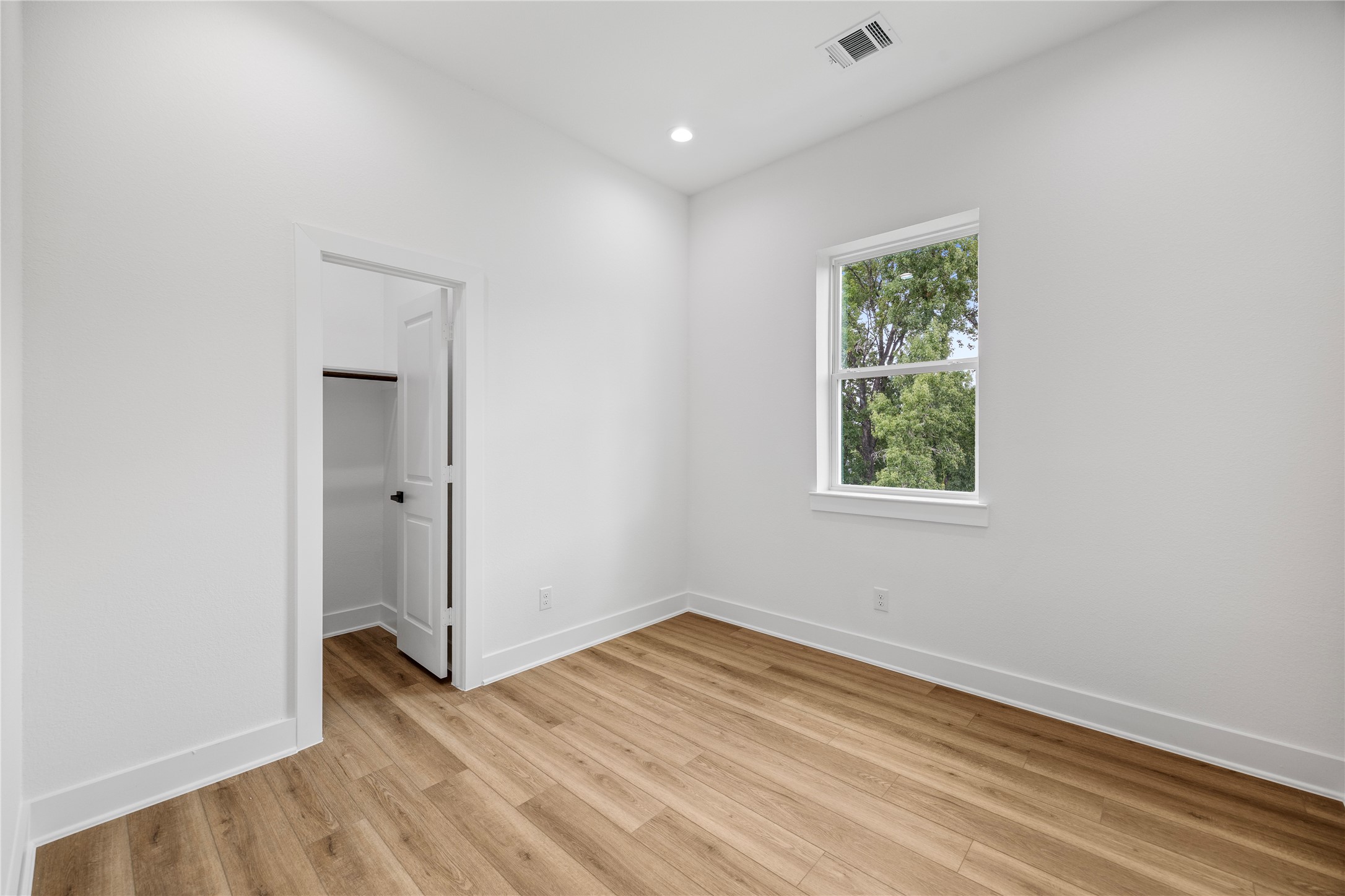 7901 Cora Street, Unit B Houston, TX 77088 - Photo 21 of 21 an empty room with wooden floor and windows