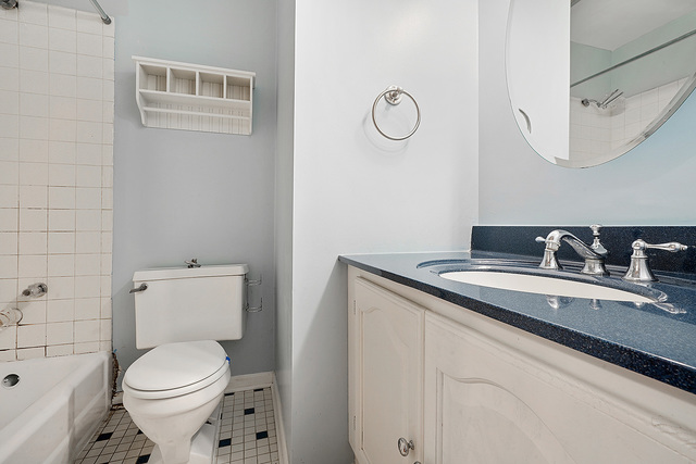 235 East Palatine Road, Unit 1B Palatine, IL 60067 - Photo 6 of 10 a bathroom with a granite countertop toilet sink and mirror