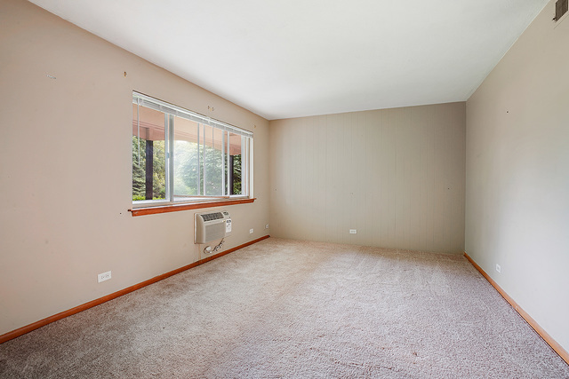 235 East Palatine Road, Unit 1B Palatine, IL 60067 - Photo 7 of 10 an empty room with windows