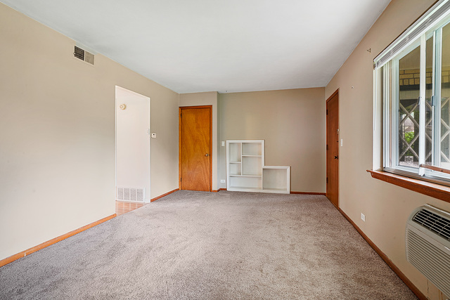 235 East Palatine Road, Unit 1B Palatine, IL 60067 - Photo 8 of 10 an empty room with closet and windows