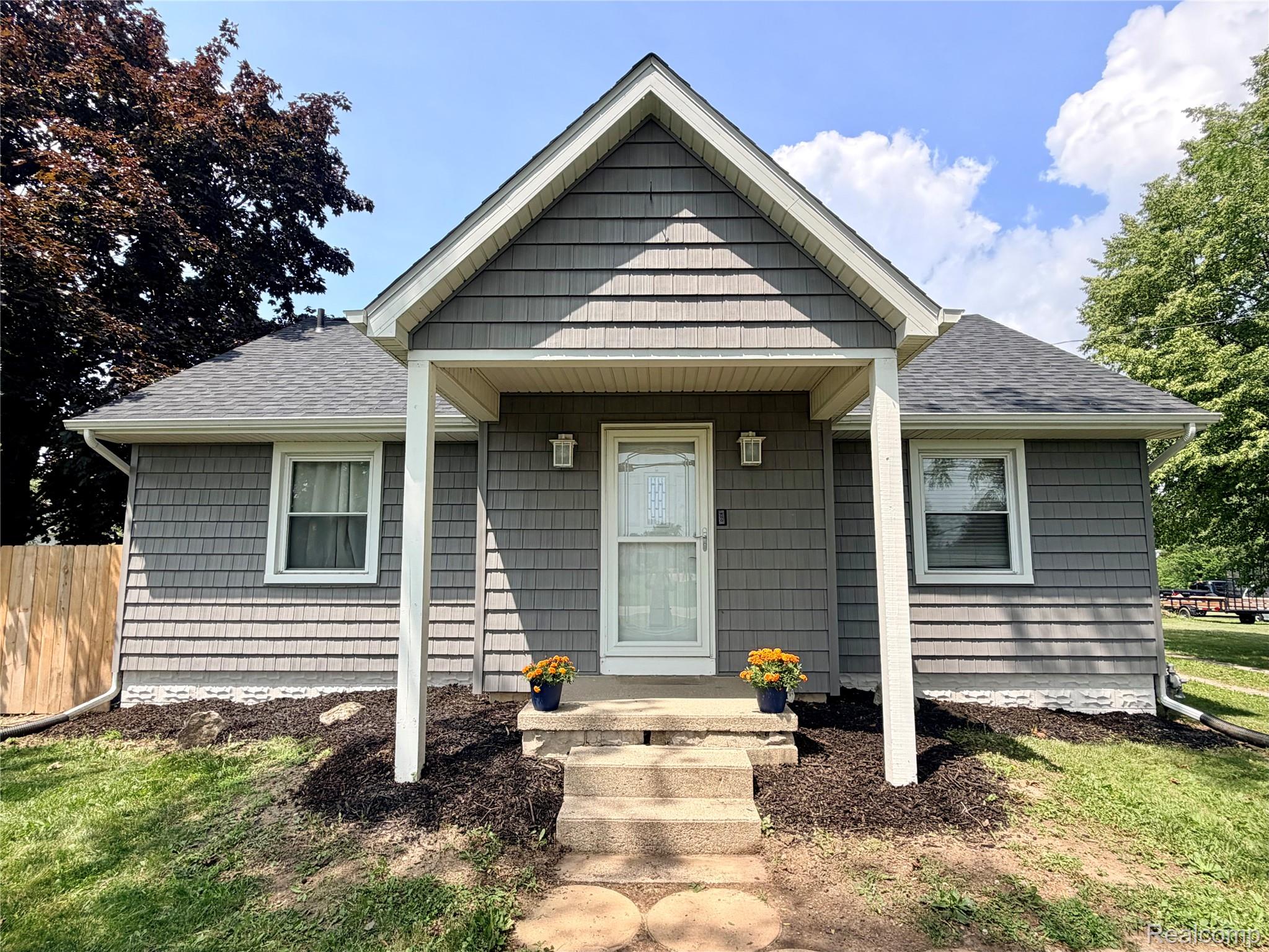 3840 East Dunbar Road Monroe, MI 48161 - Photo 2 of 38 Charming single-story residence featuring grey shingle siding and white trim