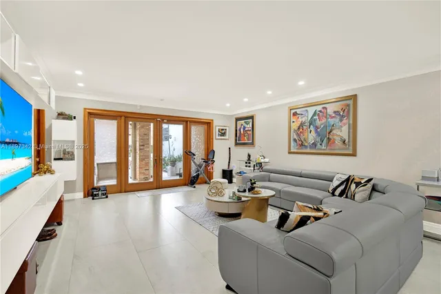 a living room with furniture and large windows