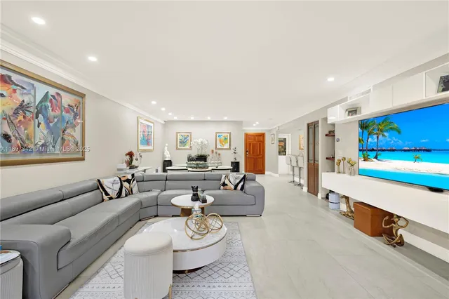 a living room with furniture a rug and white walls