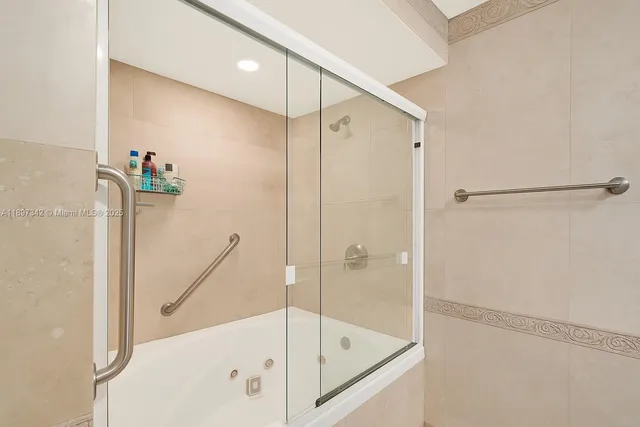 a bathroom with a bathtub and a shower