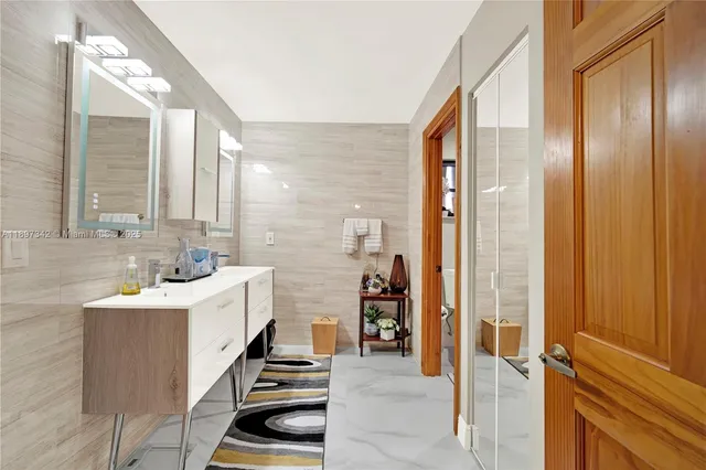 a bathroom with a sink a mirror and a shower