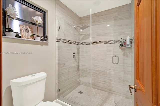 a bathroom with a shower and toilet