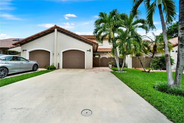 a view of a house with a yard and garage