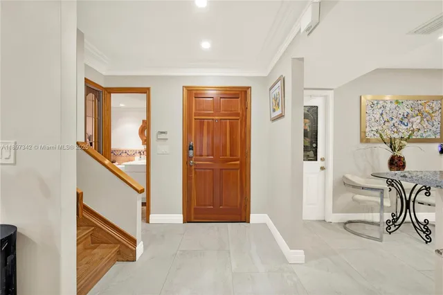 a view of a hallway with furniture and entryway