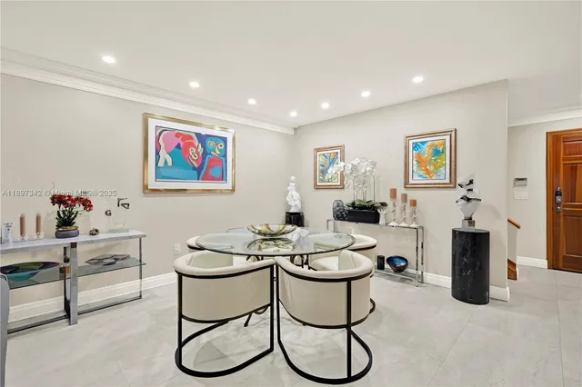 a living room with furniture a rug and white walls