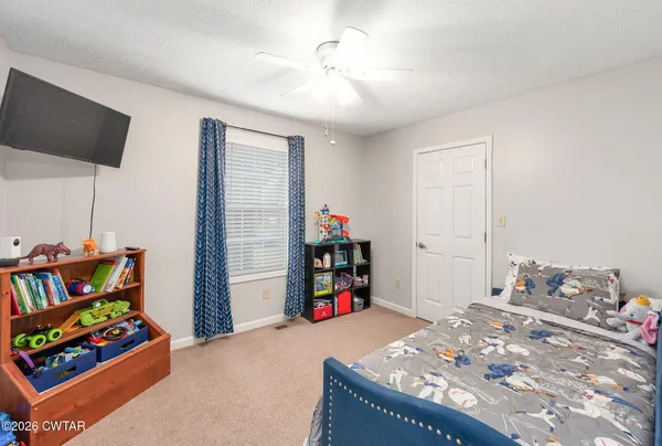 a bedroom with a bed and a couch