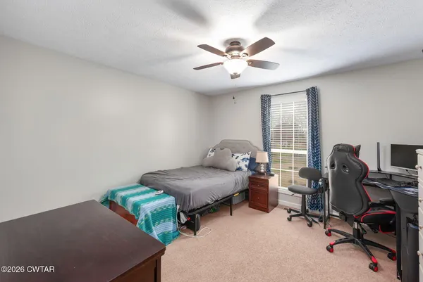 a bedroom with furniture and a window