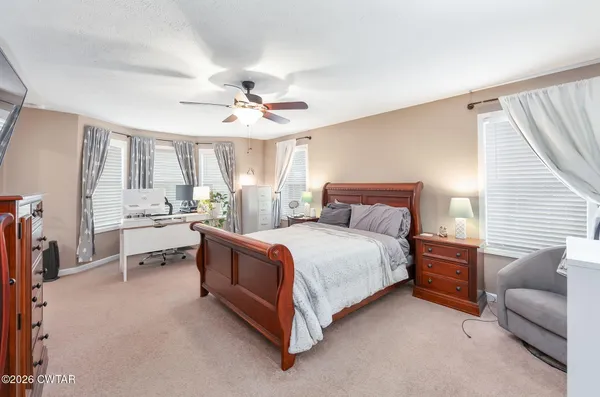a spacious bedroom with a bed and a couch