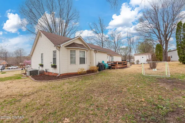a view of a house with a yard covered in snow
