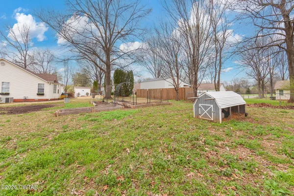 a backyard of apartments with large trees