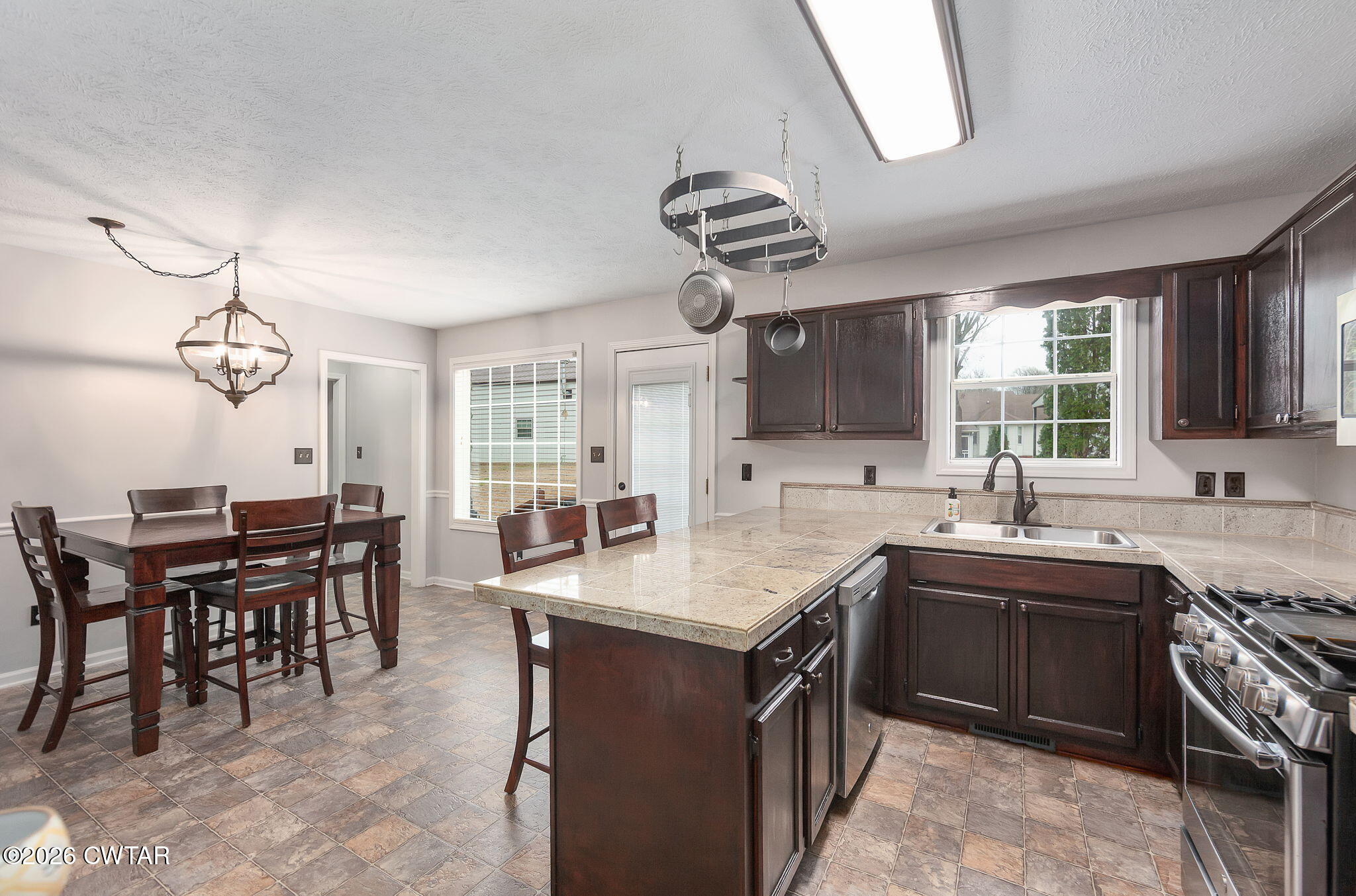 44 Ginger Lane Bells, TN 38006 - Photo 3 of 37 a kitchen with stainless steel appliances granite countertop a sink a stove and a refrigerator