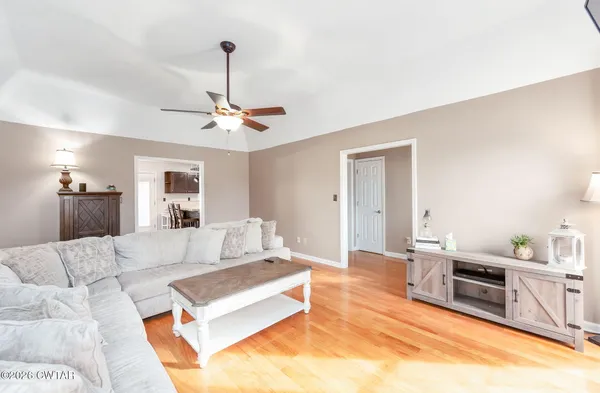 a living room with furniture and kitchen view