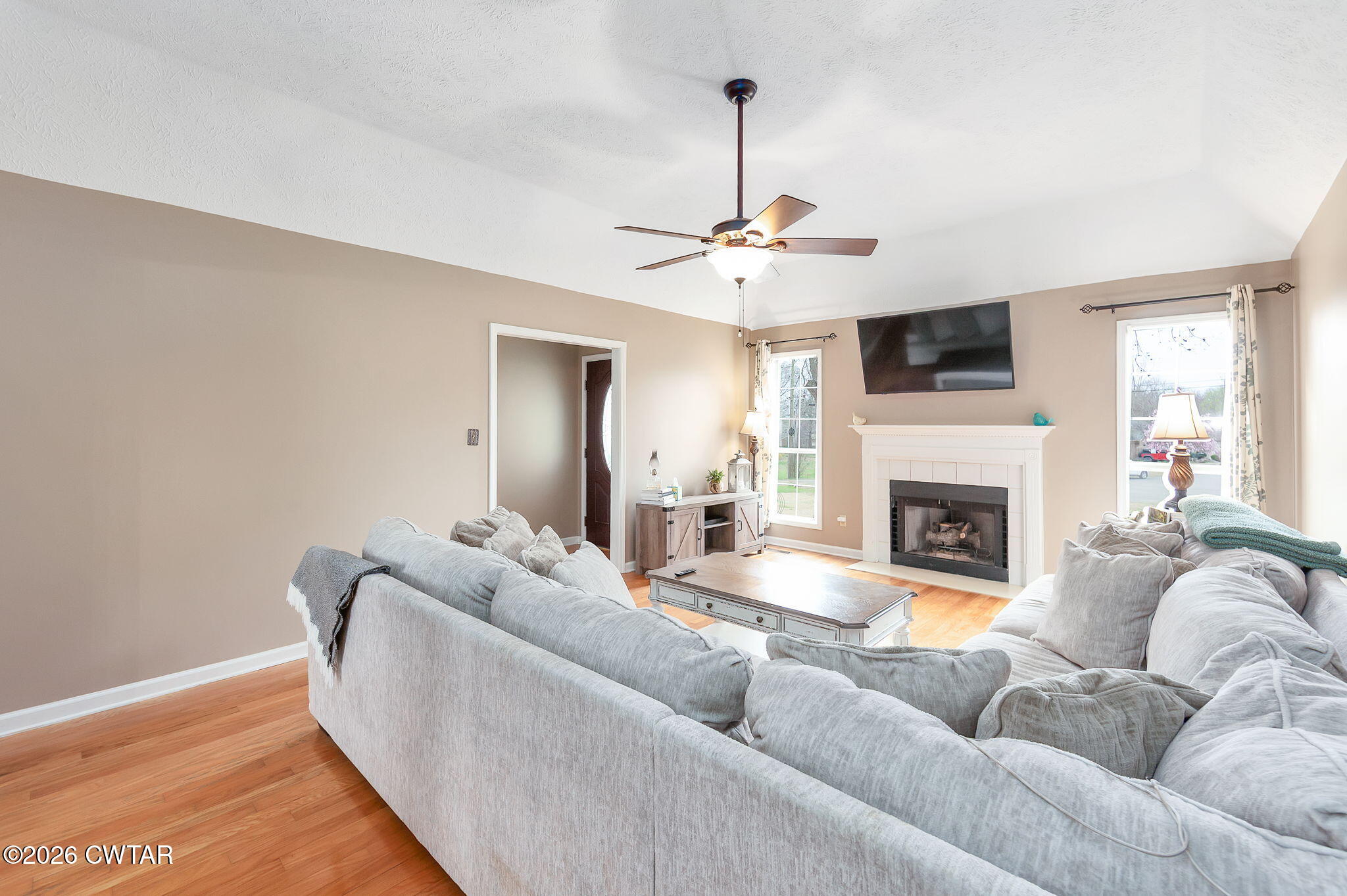 44 Ginger Lane Bells, TN 38006 - Photo 10 of 37 a living room with furniture a fireplace and a flat screen tv